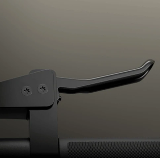 Detailed close-up of the black metal hardware and textured grip on the bike's handlebar.