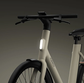 Front view of the electric bike showing a vertical integrated white LED headlight in the frame.